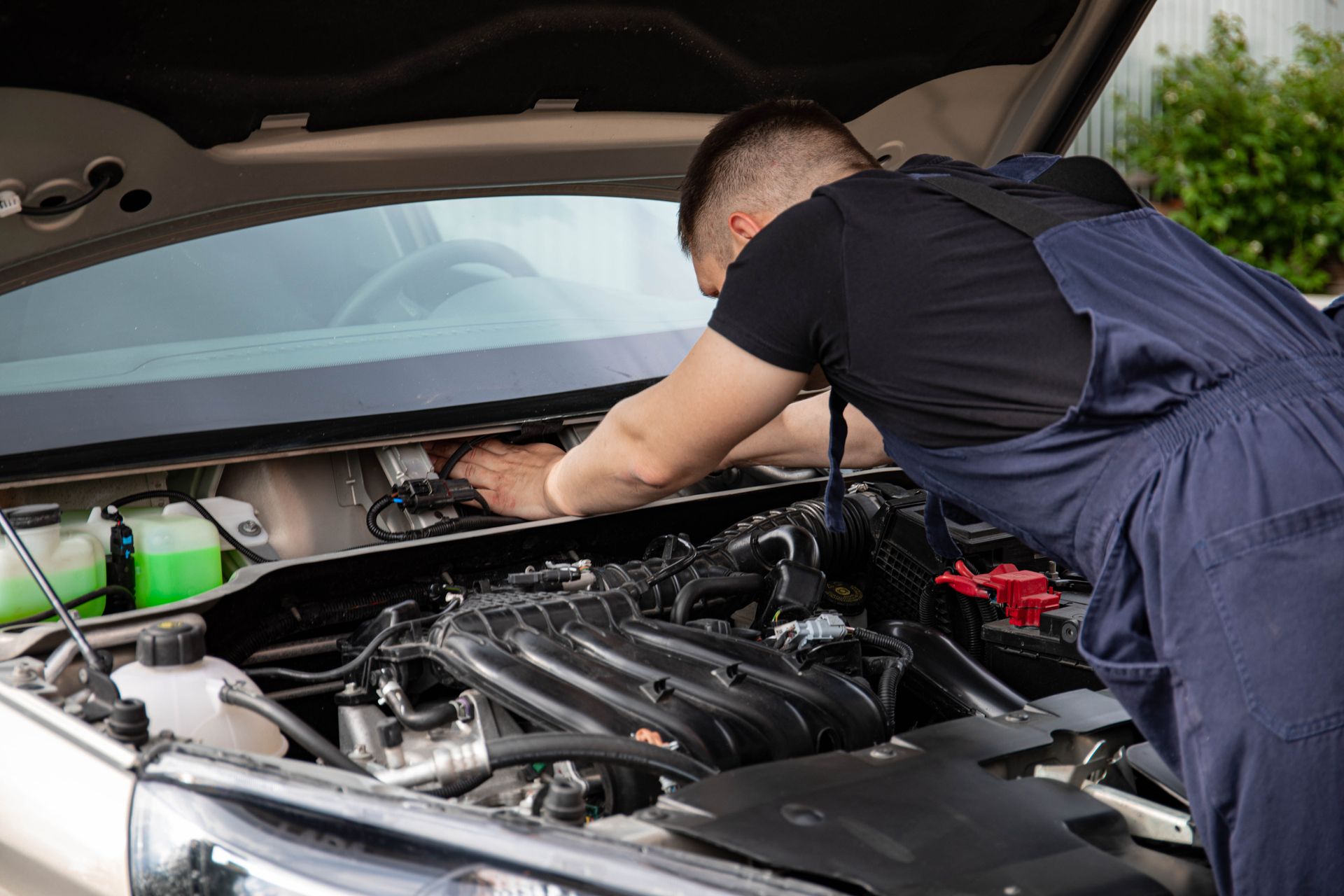 Technician working on a car engine