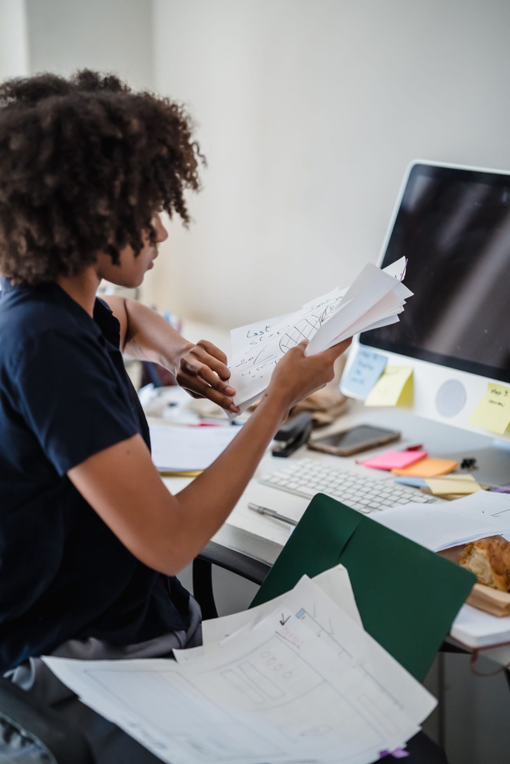 Back-office specialist reviewing documents at her desk