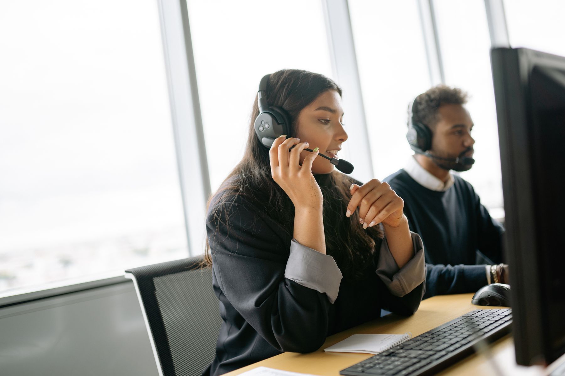 Customer service agent on a call at her workstation
