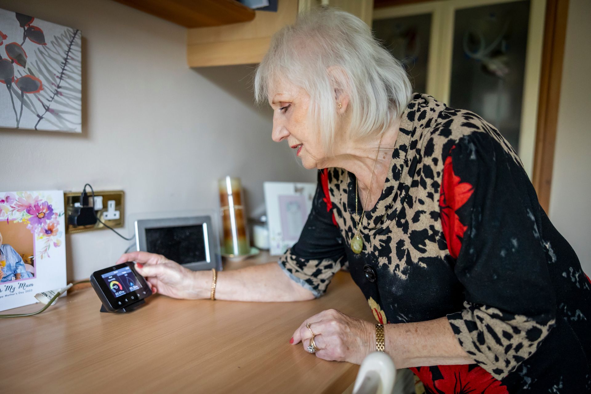 Woman checking a smart energy meter