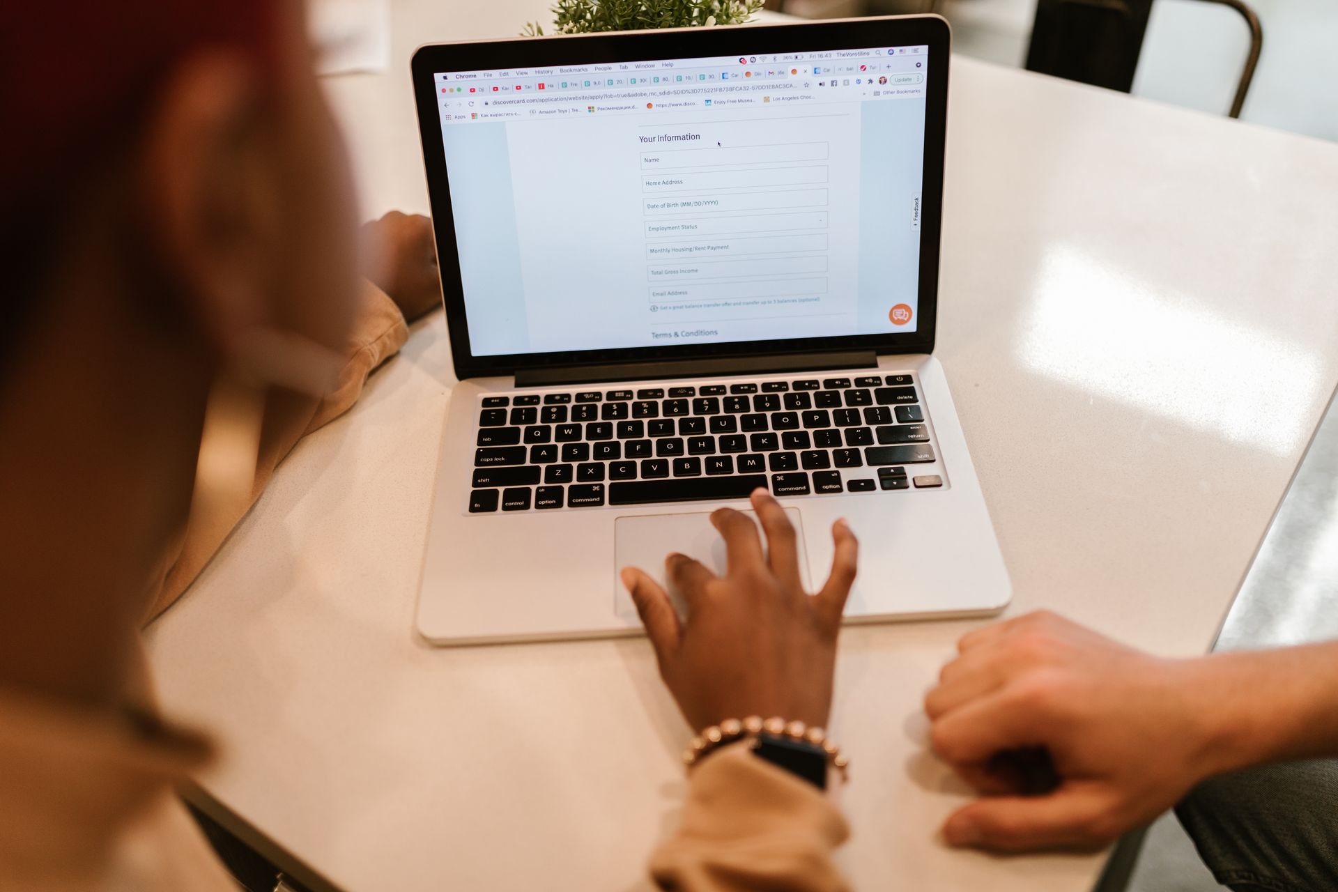 Two adults completing an online form