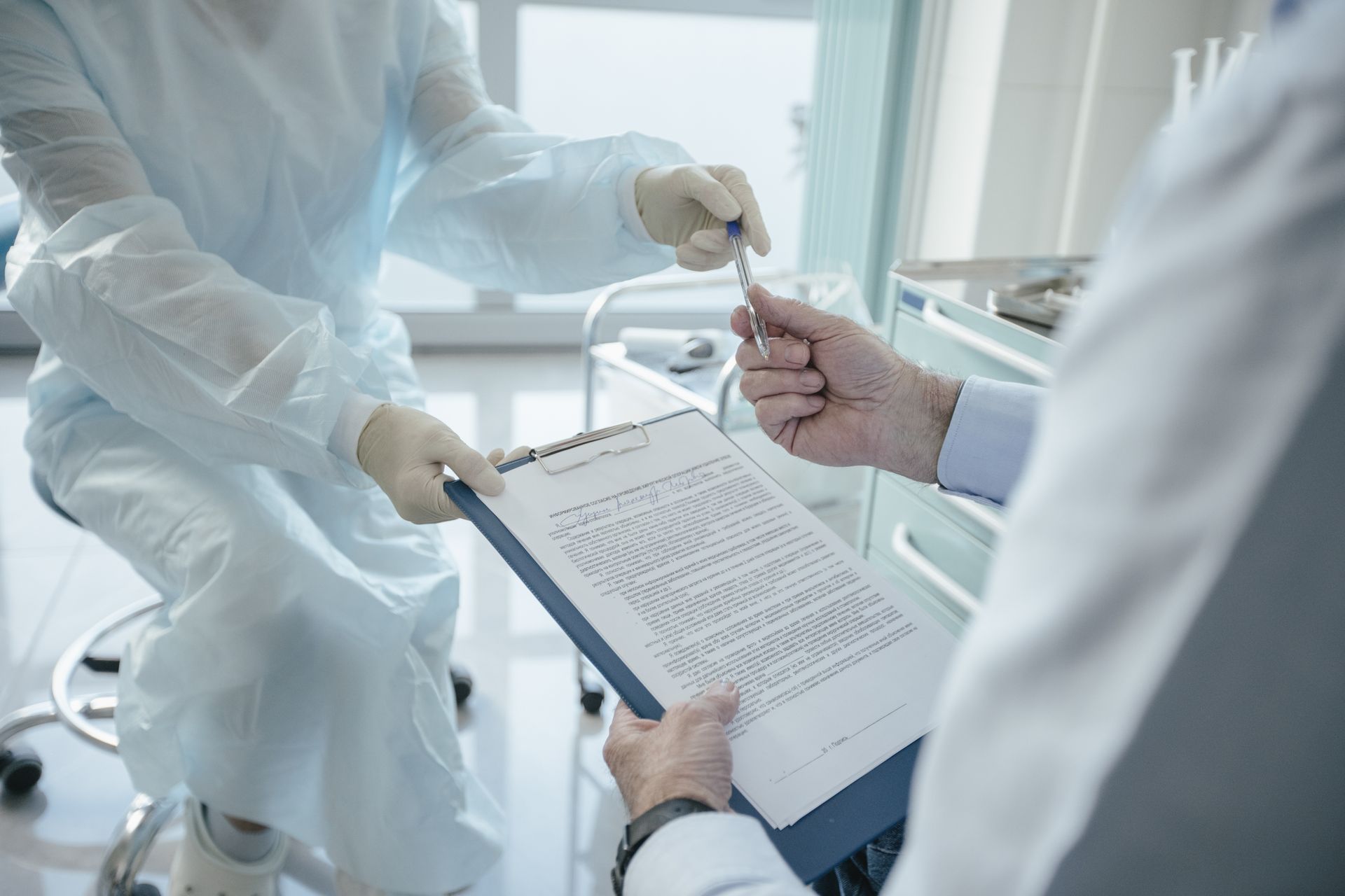 Patient signing a document at the clinic