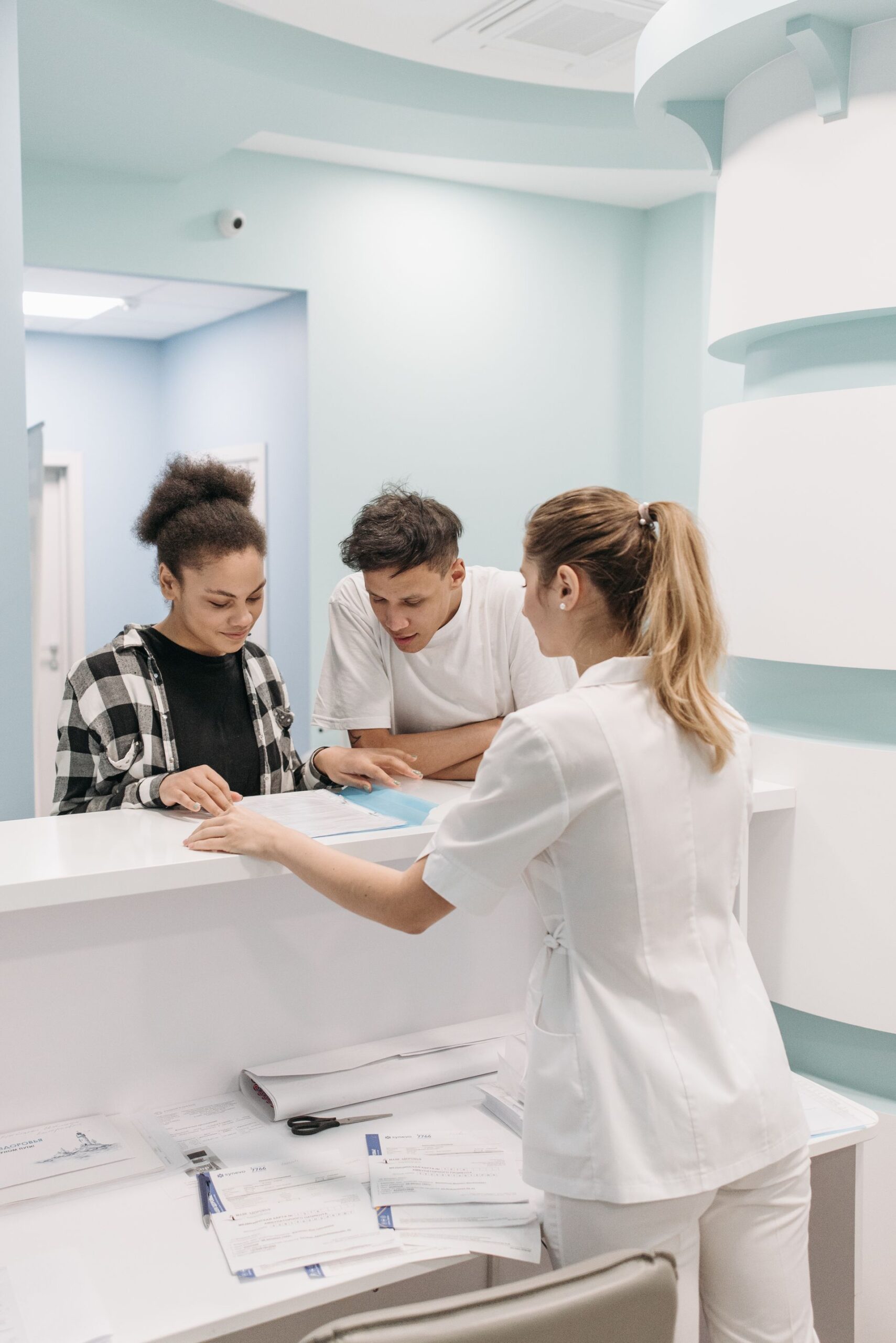 Nurse assisting patients at reception