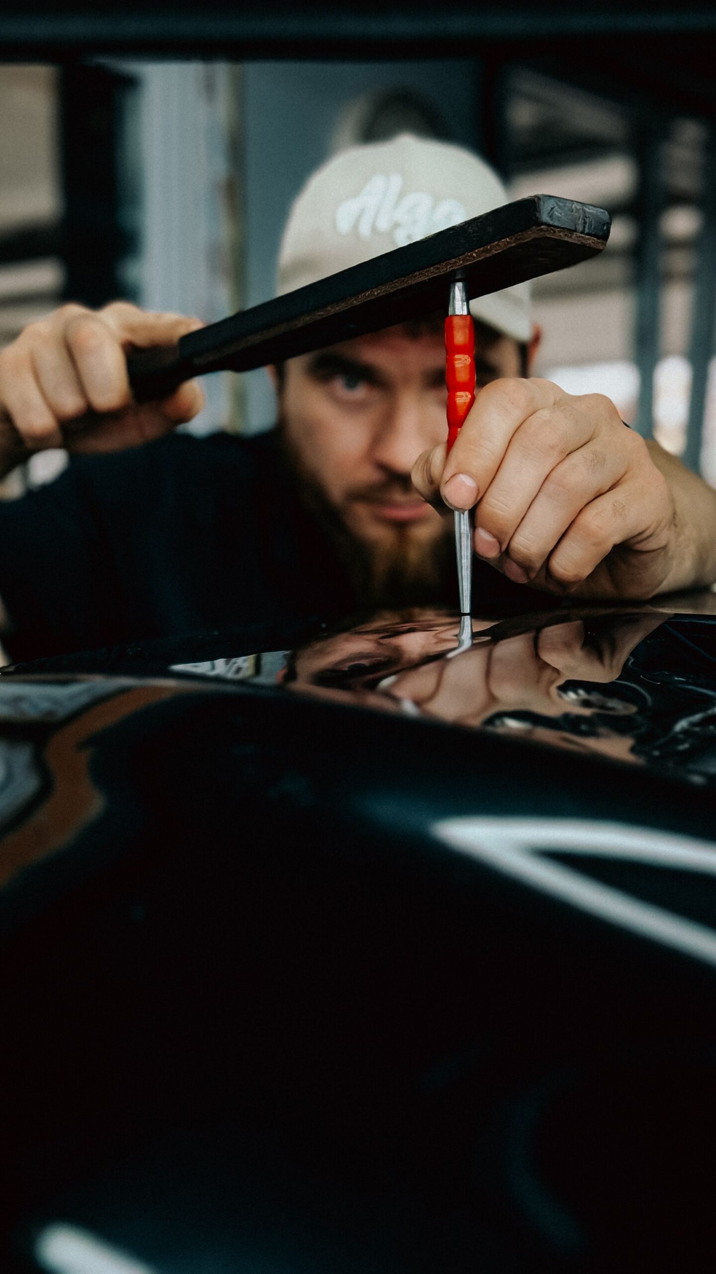Mechanic repairing a car body in a workshop
