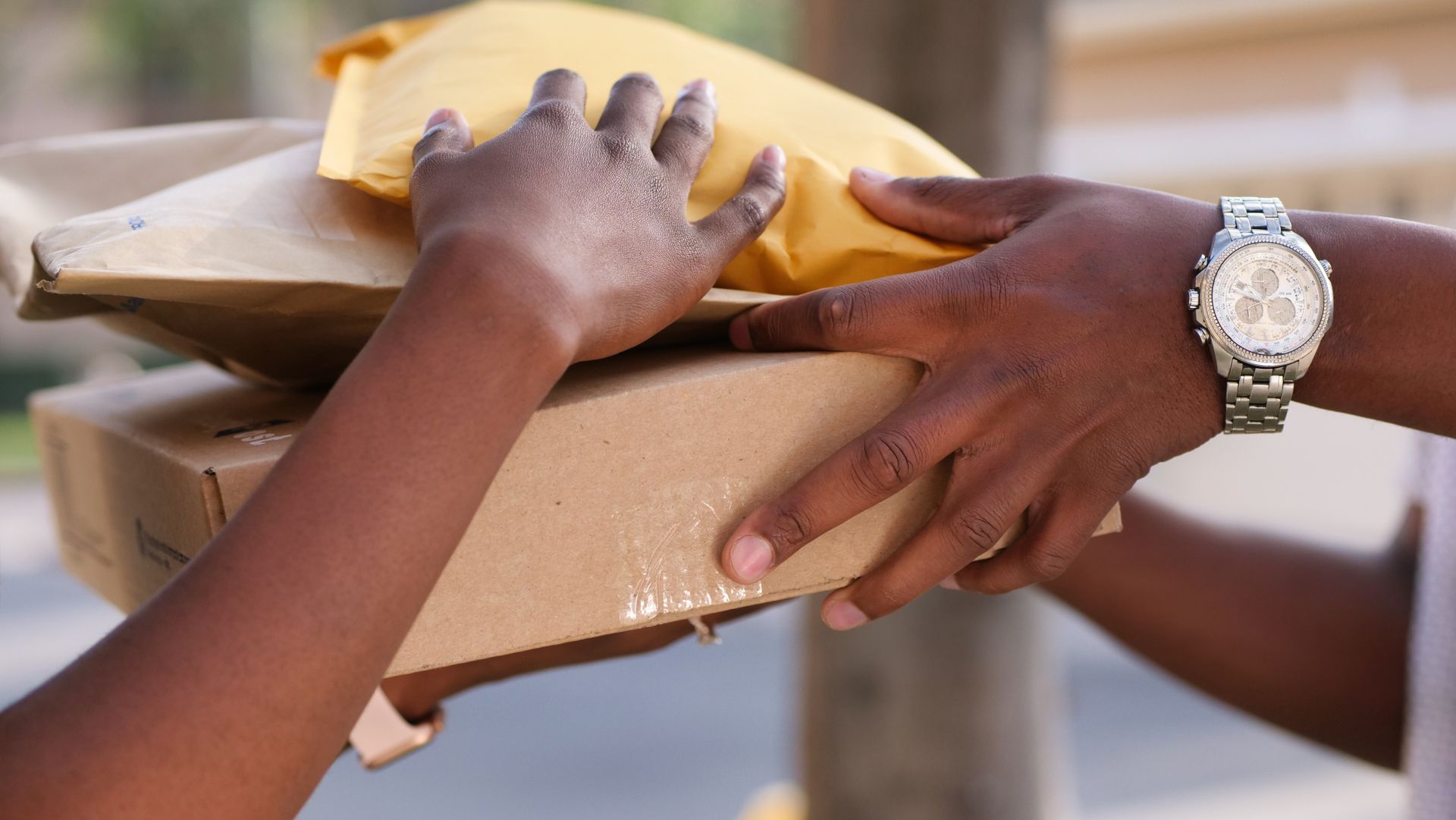 Two people exchanging parcels