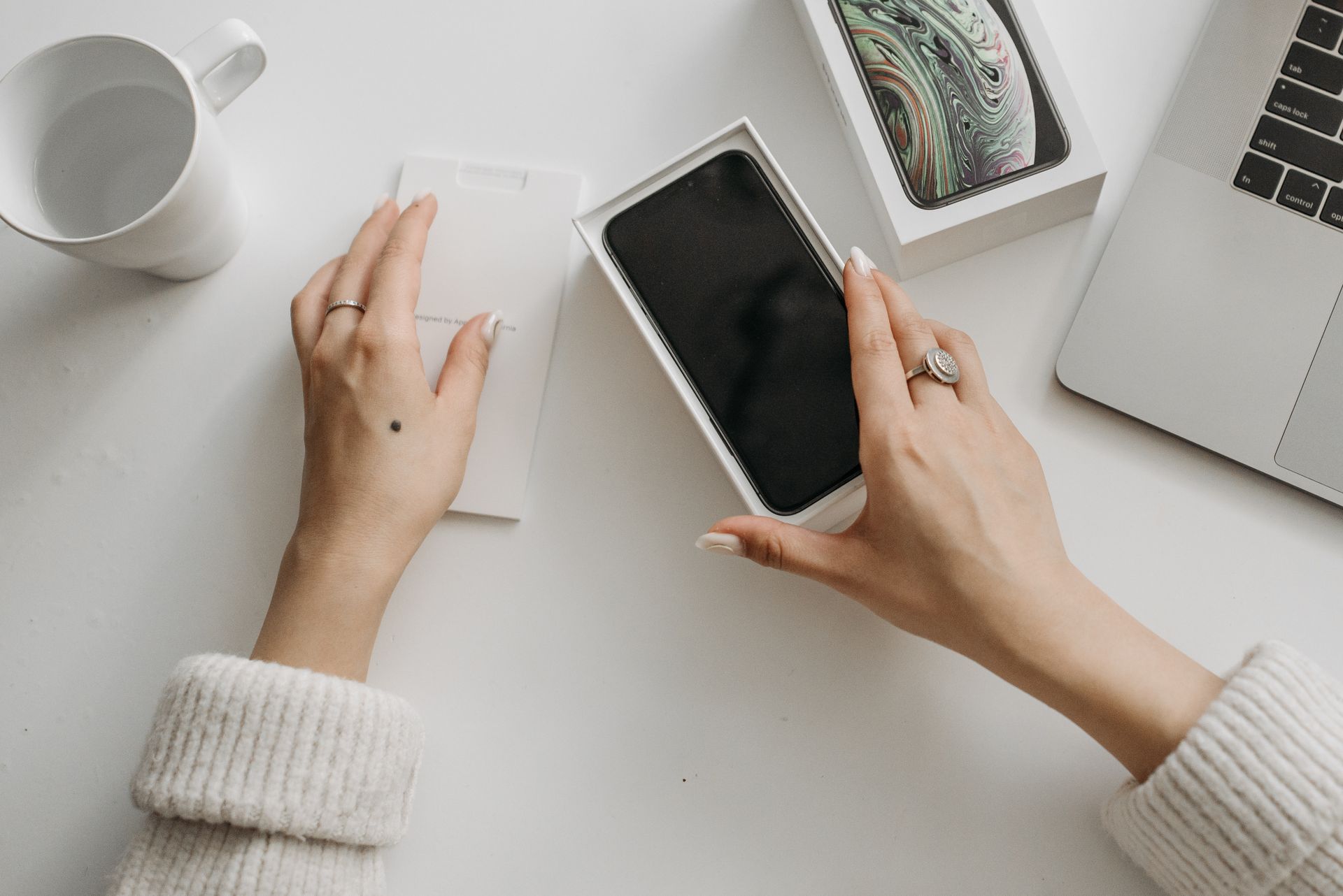 Woman unboxing a new smartphone