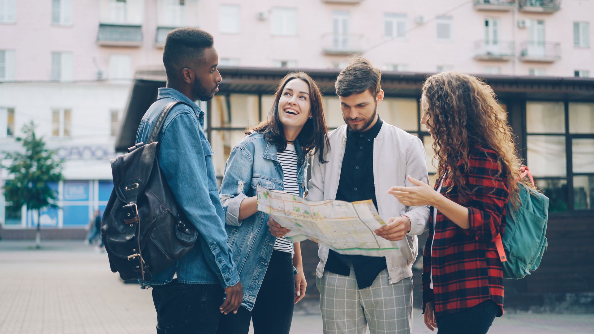 Friends reading a map in a city